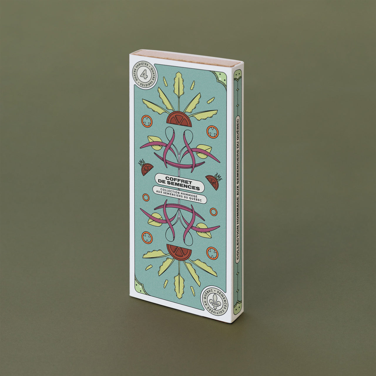 Boite rectangulaire turquoise avec des dessins de légumes. On lit : «Coffret de semences: Hommage aux semenciers du Québec»