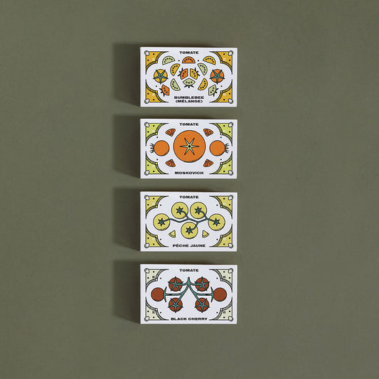 Quatre (4) petites boîtes rectangulaires, chacune avec différentes variétés de tomates représentées sur celles-ci