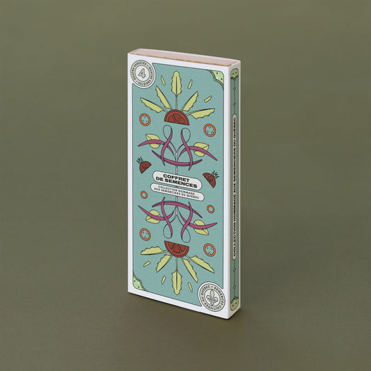 Boite rectangulaire turquoise avec des dessins de légumes. On lit : «Coffret de semences: Hommage aux semenciers du Québec»